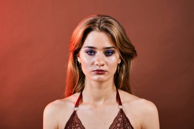 Güzel genç bir kadın portreye bakıyor. Temiz ciltli, model bir kız..