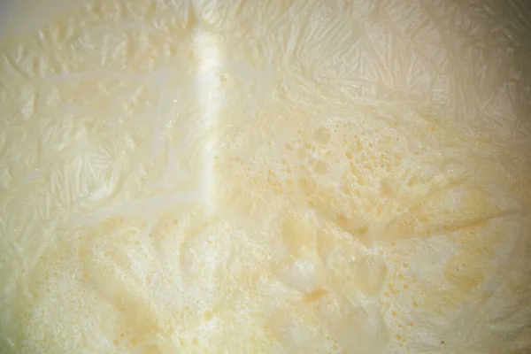 Boiled milk in a pan. Foam in milk.