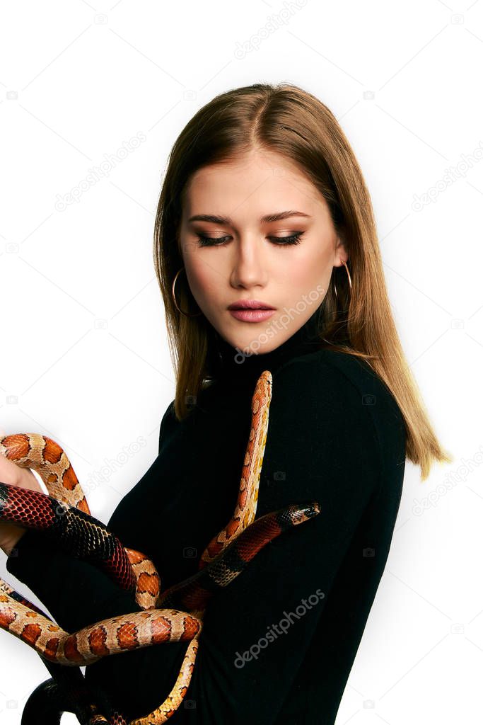 Beautiful woman in black bodywear and snake. Blonde model girl with fashion perfect make up.