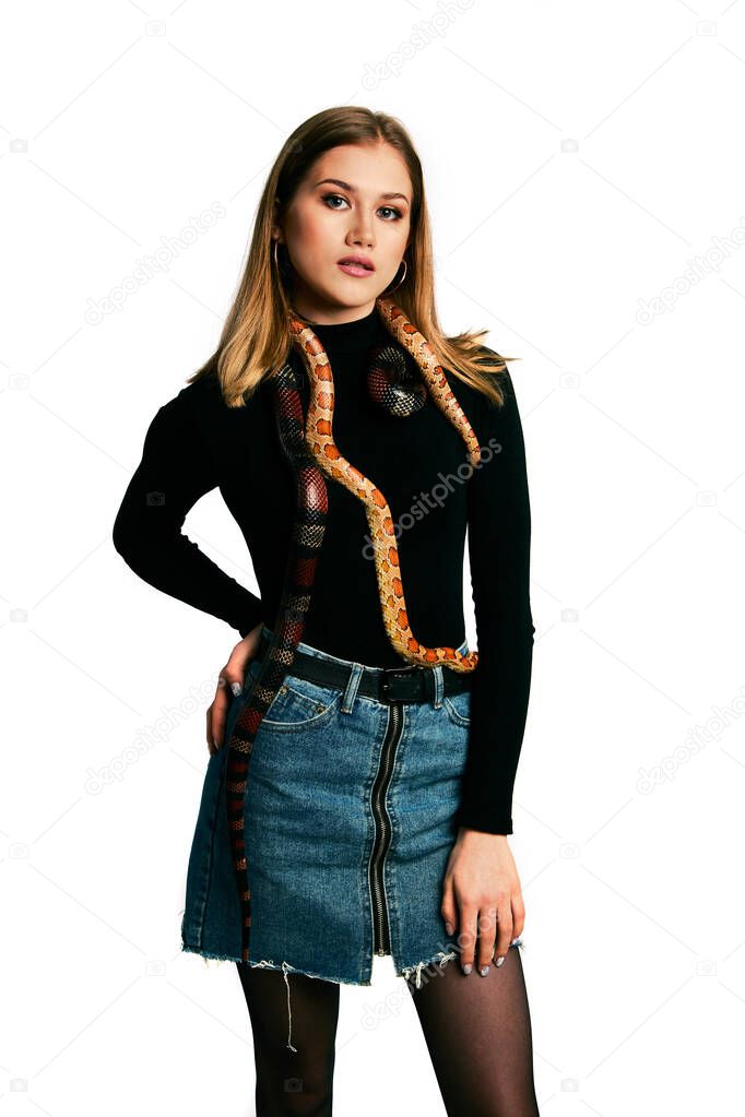 Beautiful woman in black bodywear and snake. Blonde model girl with fashion perfect make up. High end retouch. White background. Young woman with perfect fresh skin. Woman with snake around her face.