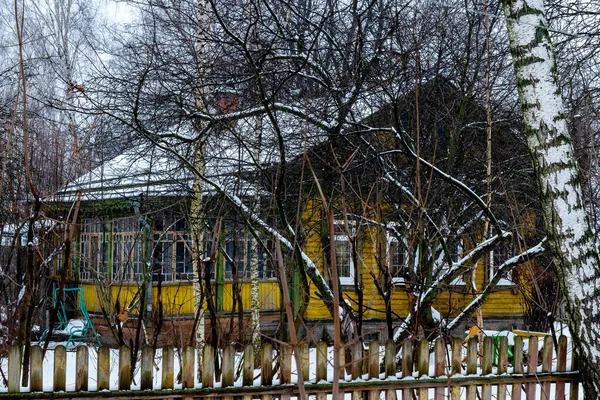 Old colorful Russian house in the suburbs in winter. Soft select