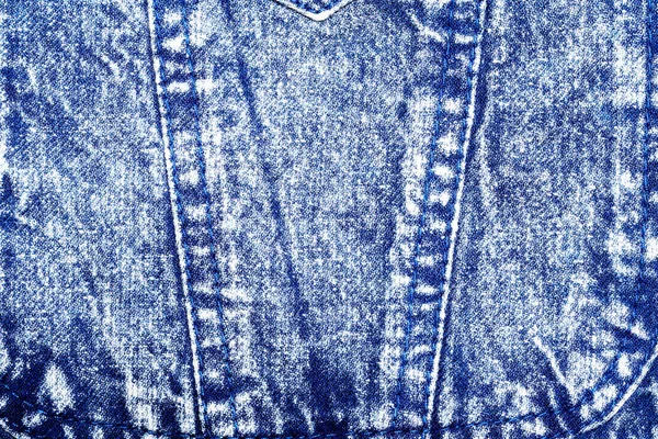 Texture of frayed jeans with a fragment of a pocket. Background — Stok fotoğraf