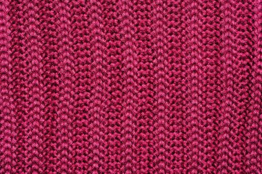 Soyut arkaplan. Burgonya renginde yün bir örgü parçası.