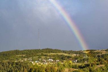 end of a rainbow in the sky in Banska Bystrica, Slovakia clipart