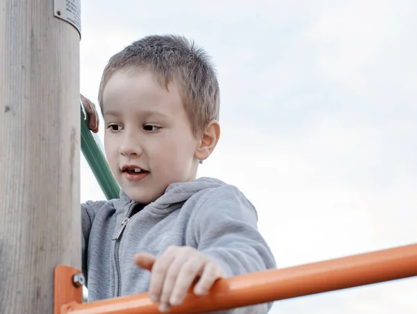 Happy boy climbing on children playground outdoors. — 스톡 사진