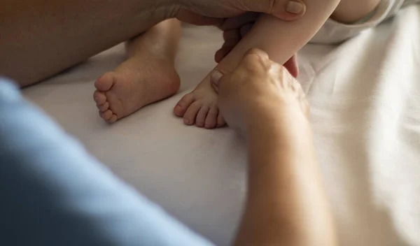 Baby having foot massage in a rehabilitation center. — Stock Photo, Image