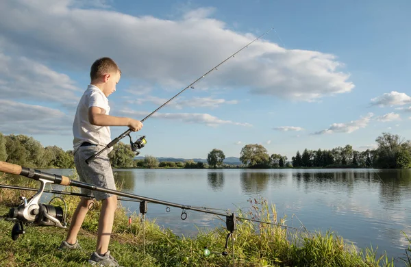 Boy fishing on a lake. Beautiful fish pond in Badin