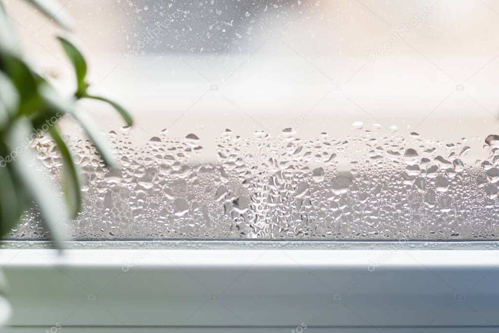 Selective focus on water condensation on window glass. Humidity in the house. Home moisture.