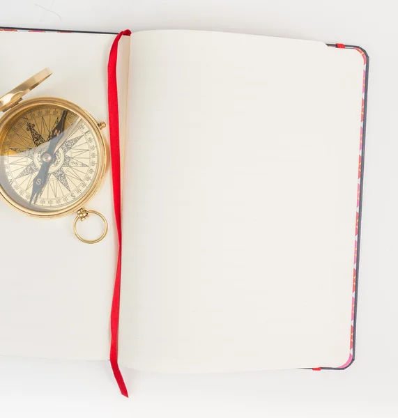 White notebook with gold compass — Stock Photo, Image