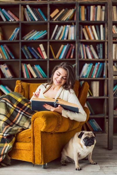 Happy reading woman in home library.