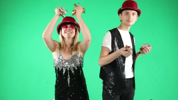 Active funny young couple dancing jumping and laughing with a funny gesture on green chroma key background. Video footage. Silly crazy happy mood — Stock Video