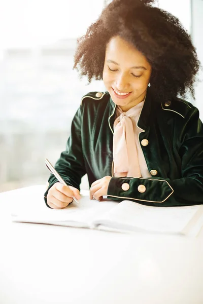 Preparation for the exam. hard work. latin brazilian girl writes in a notebook — Stock Photo, Image