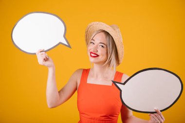 Yaz saati ruh hali sarışın kadın hasır şapka ve kırmızı kıyafet konuşma buble afiş tutuyor. Sarı arka plan