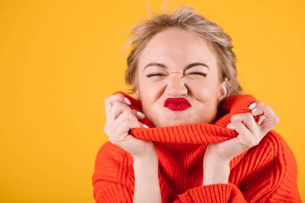 Cool silly naughty, grimacing woman portrait in red jumper. Yellow colorful background — Stock Photo, Image