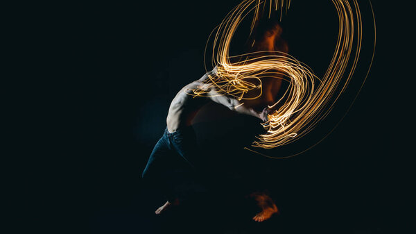 Dancing with fire. Emotional metaphorical expression of feelings. Long exposure artistic photo