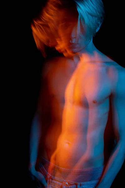 portrait of young naked man looking aside. Blue and orange complementary colors. Creative photos series allegorical metaphorical representation of human emotions. pensive bewildered confused look.