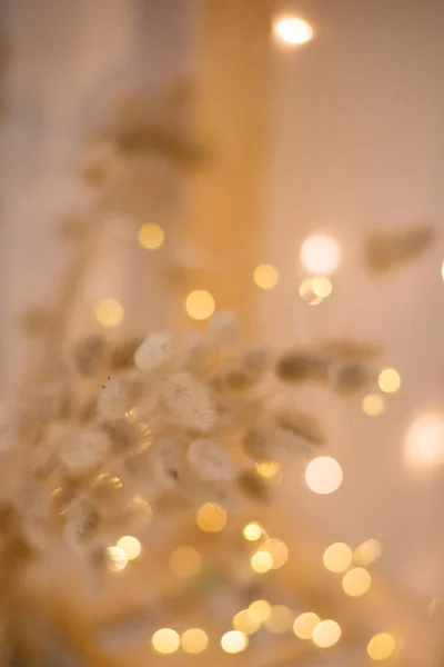 delicate Golden color against the background of blurred Christmas lights