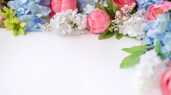 Flower frame, banner. Postcard with blue and pink flowers: hydrangea, peonies on a white background. Space for text