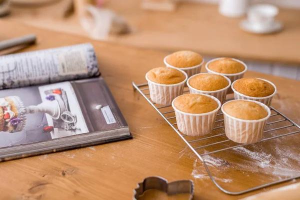 Cupcakes on a wooden kitchen table in a top view