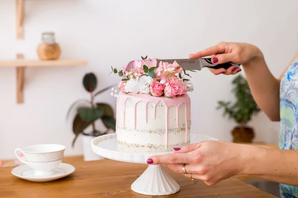 Cut the cake. Close-up of women\'s hands cutting the cake with a knife..