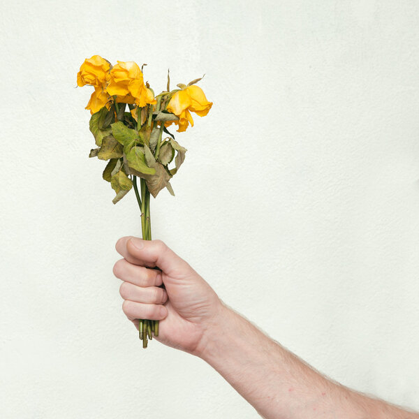 Man's hand with dead bouquet