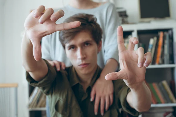 Young Man Makes Frame Gesture His Girl Stand Him Focus Royalty Free Stock Images