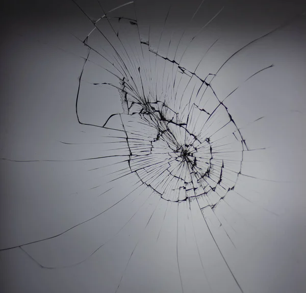 Broken glass lines on dark gray background. Web of damaged window. — Stock Photo, Image