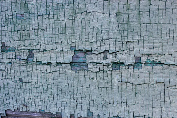 木製の表面に古い緑色の割れた塗料の体の抽象化 — ストック写真
