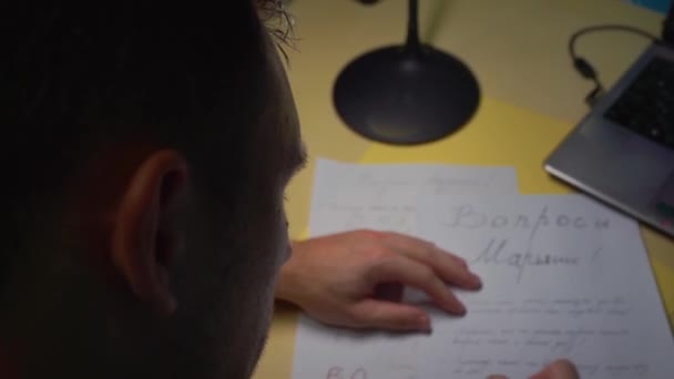 Close-up. The guy writes a message, letter to his girlfriend before the wedding — Stock Video