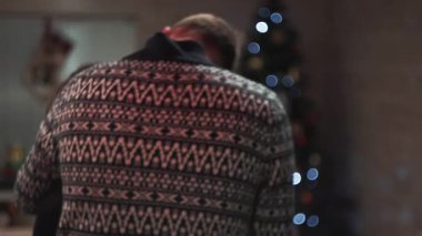 Close-up. The guy and the girl hug and kiss while standing with their backs to the camera.