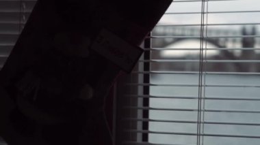 Gift sock, hanging blinds, window, morning, after new year, Christmas, January 1