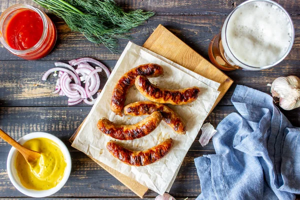 Grilled sausages with mustard and beer. German cuisine.