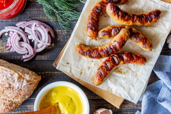 Grilled sausages with mustard. Onion. Bread. German cuisine.