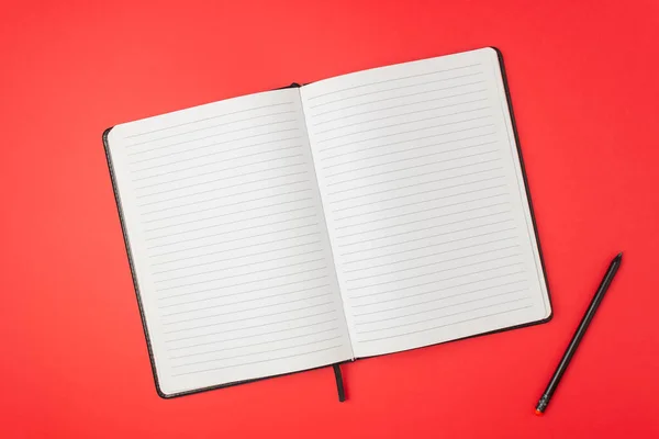 Notebook on a red background. Design. Minimal concept. Flat lay. Mock up. Copy space