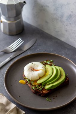 Avokado ve haşlanmış yumurtalı sandviç. Sağlıklı vejetaryen yemekleri yemek. Kahvaltı.
