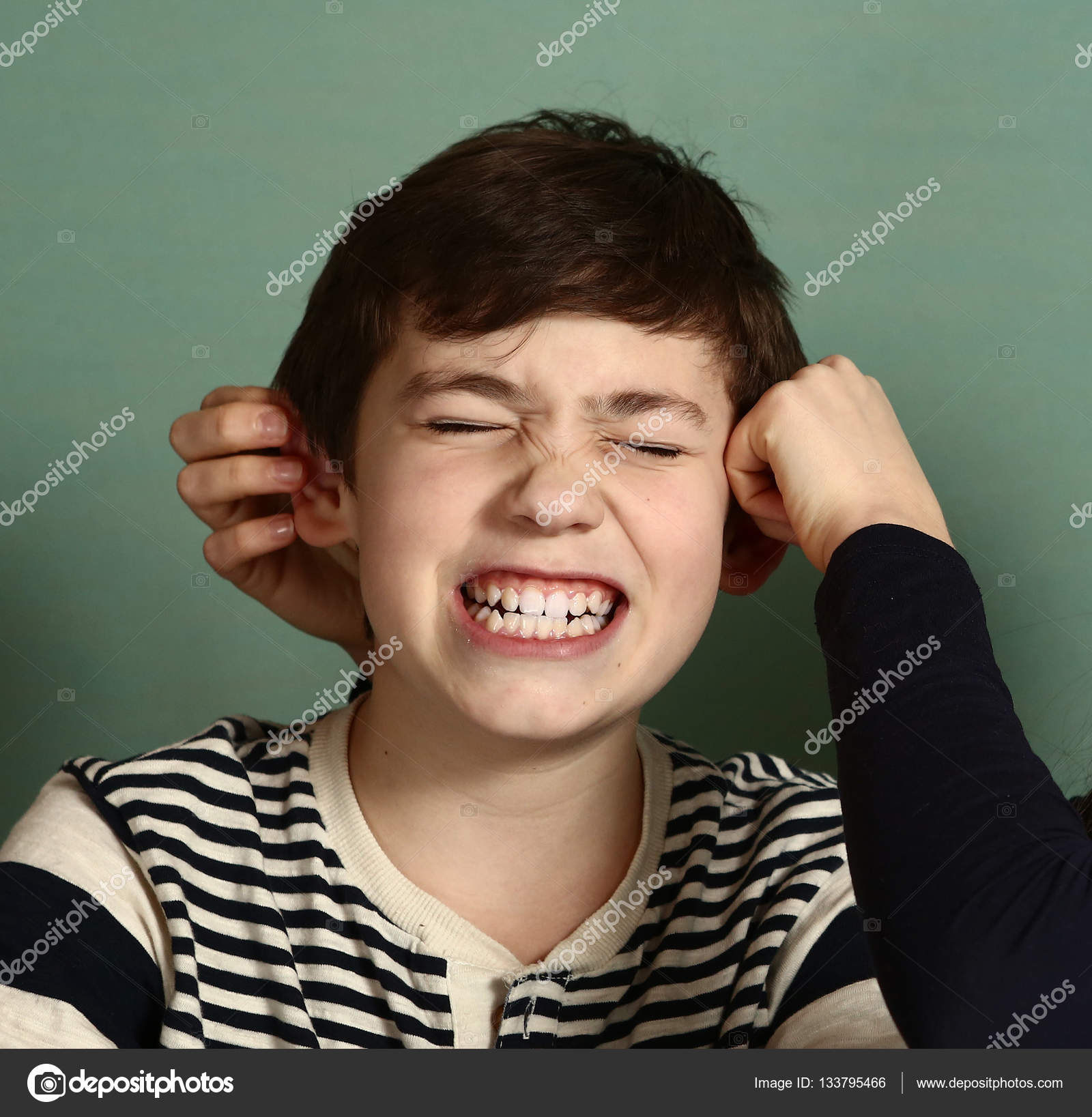 Boy being pulled by ears — Stock Photo © Ulianna 133795466