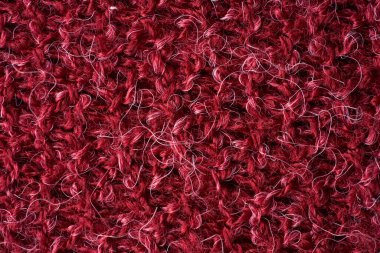 Yünlü yün örgü kumaşın yakın kırmızı dokusu. Kırmızı kumaş deseni. Yüksek kaliteli makro fotoğrafçılık.