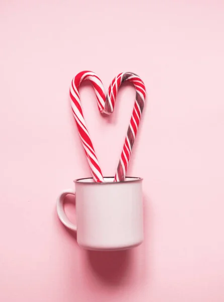 Pink Christmas picture of cup with two candies . — Stock Photo, Image