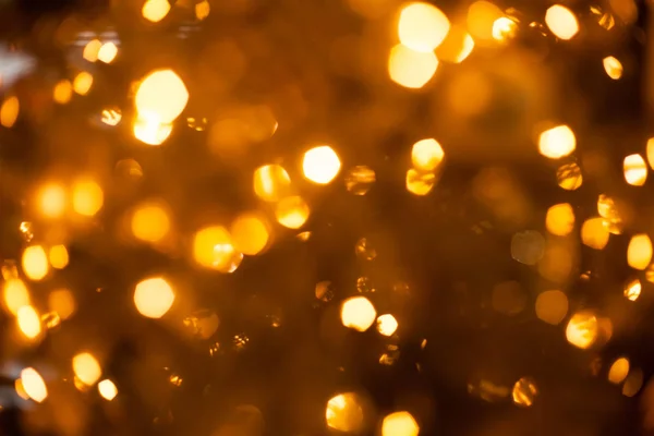 Christmas blurred golden lights out of focus on the tree, festive christmas background