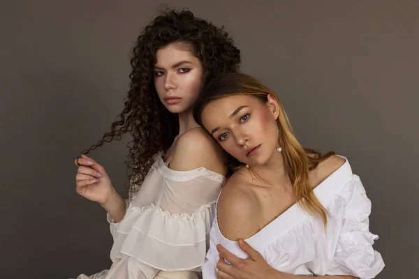 Beauty diversity: blonde and brunette young girls