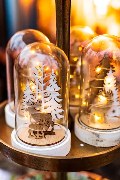 Christmas decoration: Wooden figures of moose in forest in a glass dome
