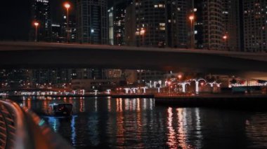 Dubai Marina tekne üzerinde gece ışık sokak görünümü.