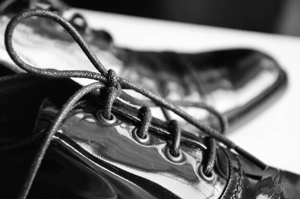 Black oxford shoes isolated on white background, patent leather shoes closeup