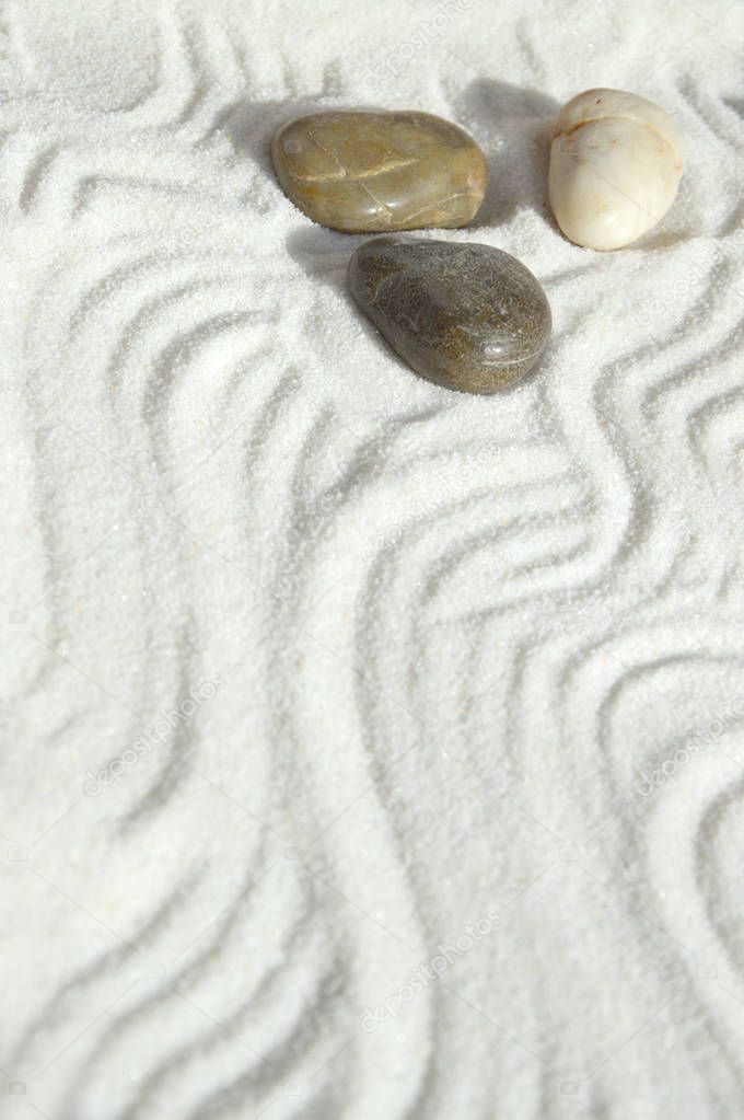 Pebbles in the sand, a background of appeasement