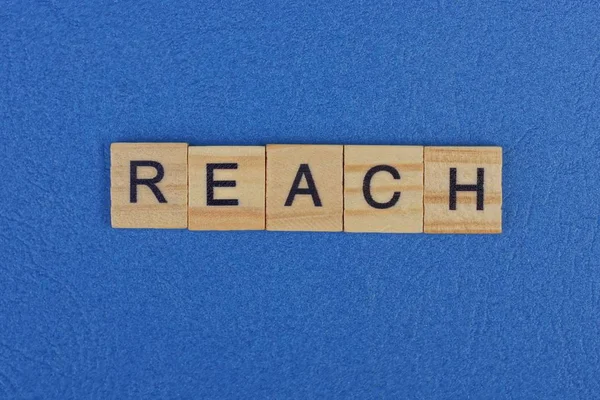 Word Reach Made Brown Wooden Letters Lies Blue Table — ストック写真