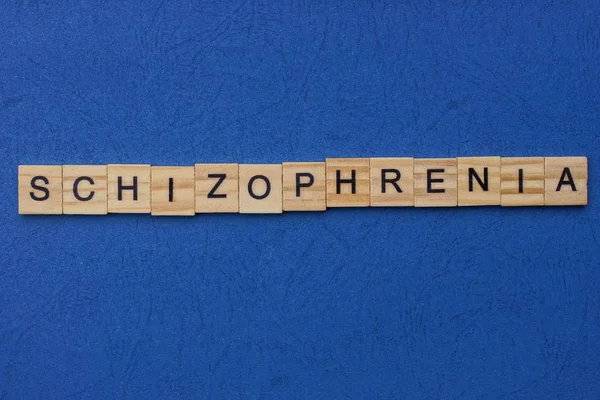 Word Schizophrenia Made Brown Wooden Letters Lies Blue Table — Stock Photo, Image