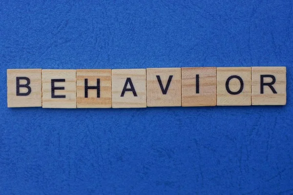 Word Behavior Made Brown Wooden Letters Lies Blue Table — Stock Photo, Image