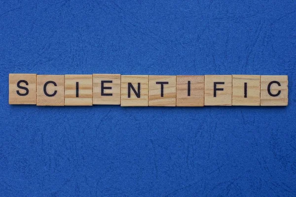 Word Scientific Made Brown Wooden Letters Lies Blue Table — Stock Photo, Image