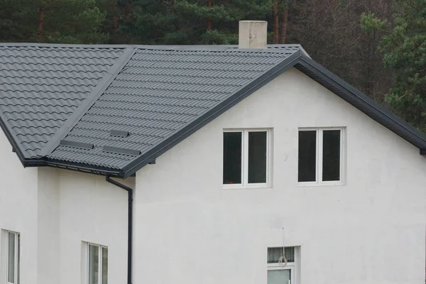 一幢白色大房子的一部分 窗户在灰色瓷砖屋顶下 — 图库照片