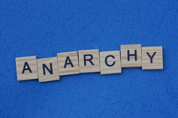 Word Anarchy Made Wooden Letters Lies Blue Background — Stock Photo, Image